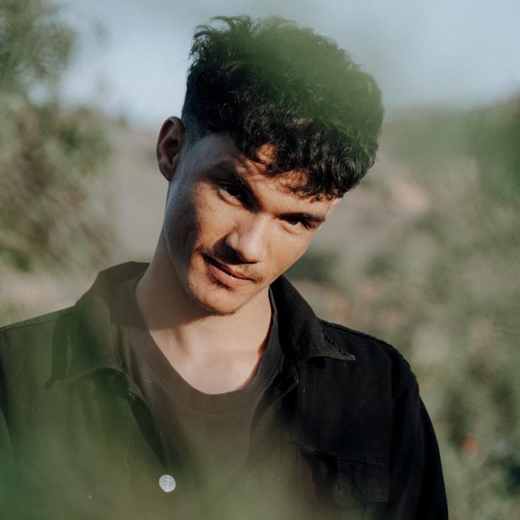 Kaveri Mehta, Lead Design Curator at Drift Meadow Leaf, reviewing corporate floral arrangements